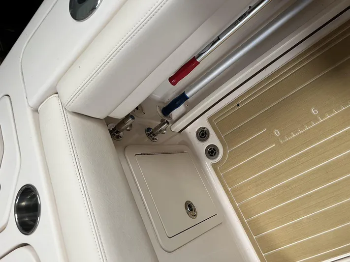  Yacht Photos Pics 2018 Grady-White Canyon 336 boat interior, featuring rod holders and storage compartment.