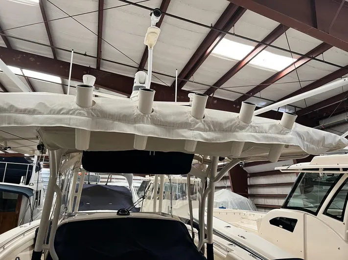  Yacht Photos Pics 2018 Grady-White Canyon 336 boat in storage, featuring rod holders and canopy.