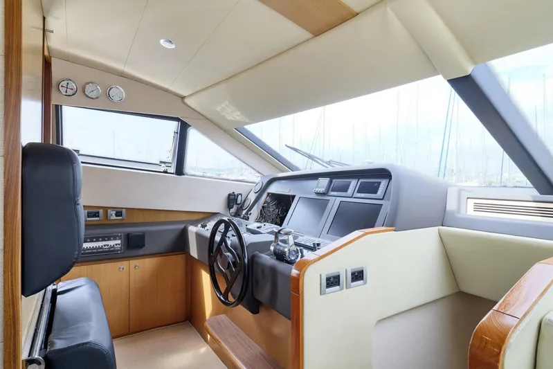 M/y Flow Yacht Photos Pics Interior helm of 2008 Ferretti 681 yacht, featuring modern controls and luxurious seating.