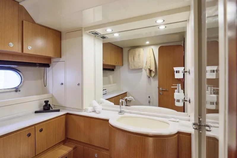 M/y Flow Yacht Photos Pics Luxurious bathroom interior of 2008 Ferretti 681 yacht with wooden cabinetry and modern fixtures.
