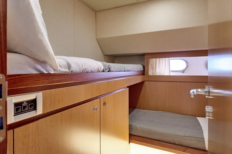 M/y Flow Yacht Photos Pics Interior of 2008 Ferretti 681 yacht featuring cozy bunk beds and wooden cabinetry.