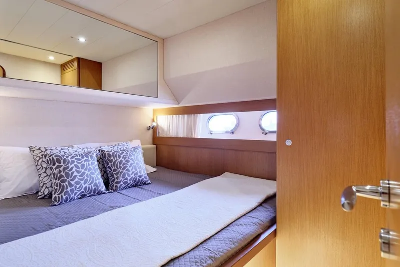 M/y Flow Yacht Photos Pics Luxurious cabin interior of 2008 Ferretti 681 yacht with cozy bedding and porthole windows.