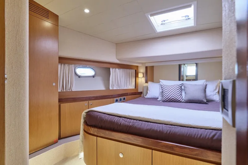 M/y Flow Yacht Photos Pics Luxurious bedroom interior of 2008 Ferretti 681 yacht with elegant wood finishes.
