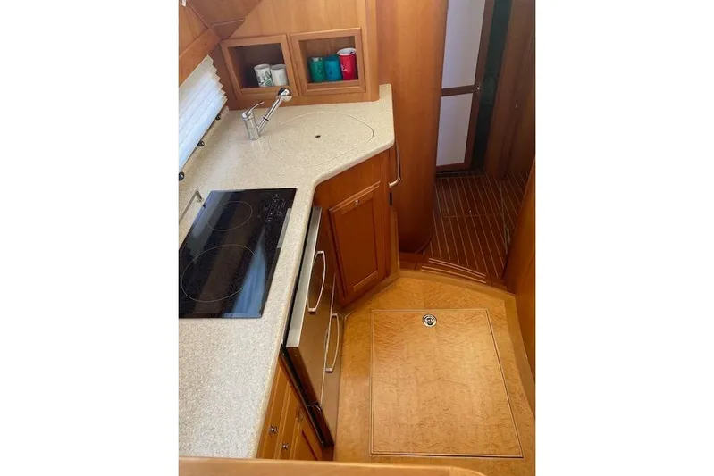  Yacht Photos Pics 2010 Sabre 38 Express yacht interior kitchen with modern appliances and wooden cabinetry.