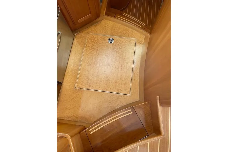  Yacht Photos Pics 2010 Sabre 38 Express interior with wooden flooring and storage compartment.