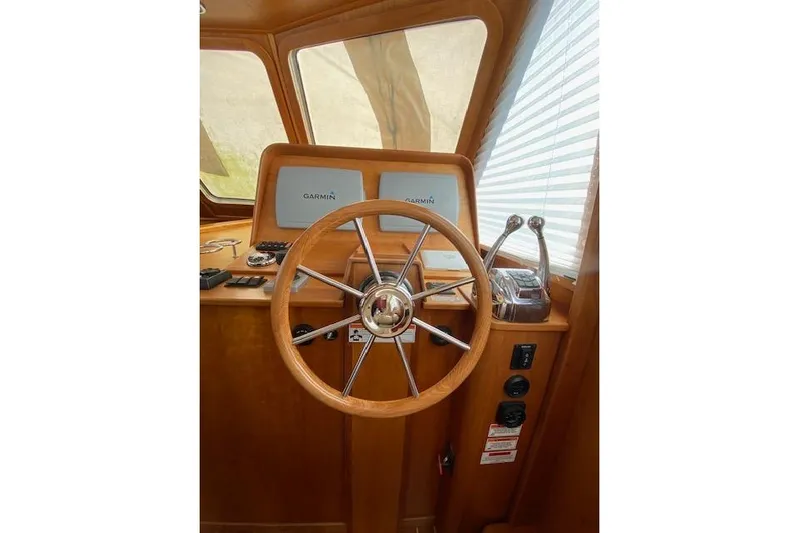  Yacht Photos Pics Steering wheel and controls of 2010 Sabre 38 Express boat with Garmin displays.