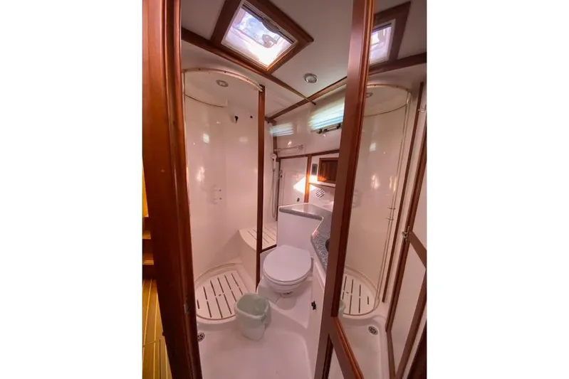  Yacht Photos Pics 2010 Sabre 38 Express yacht bathroom with shower, toilet, and wooden accents.