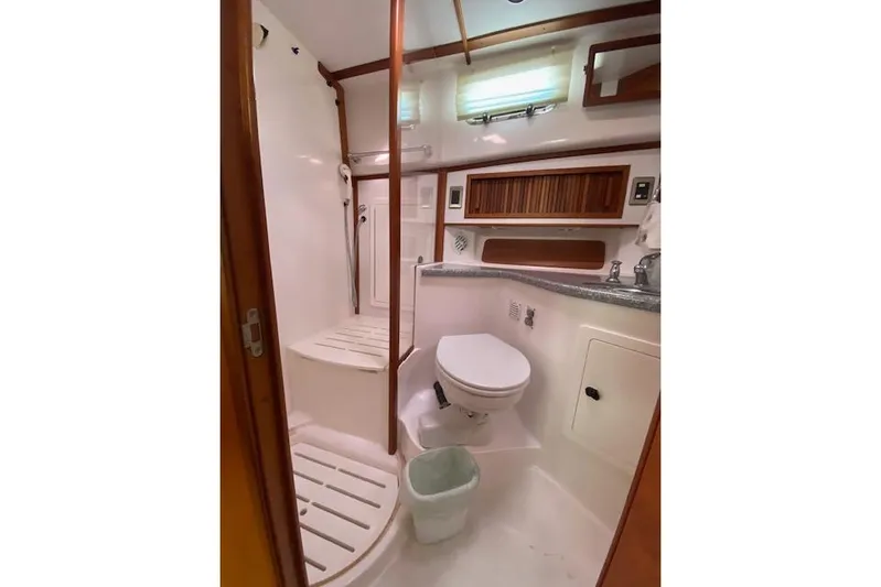 Yacht Photos Pics 2010 Sabre 38 Express yacht bathroom with shower, toilet, and wooden accents.