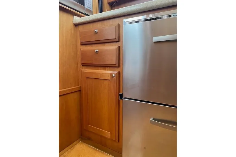  Yacht Photos Pics Wooden cabinetry and stainless steel fridge in 2010 Sabre 38 Express yacht interior.