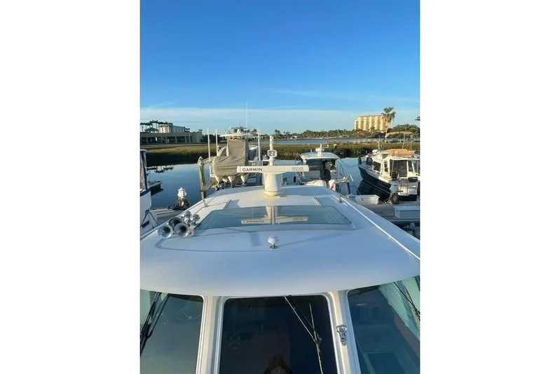  Yacht Photos Pics 2010 Sabre 40 Sedan yacht docked at marina under clear blue sky.