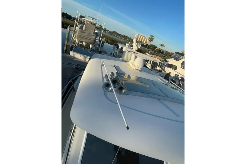  Yacht Photos Pics 2010 Sabre 40 Sedan yacht with Garmin equipment, docked under clear blue sky.