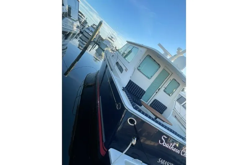  Yacht Photos Pics 2010 Sabre 40 Sedan yacht docked in marina, featuring sleek design and spacious deck.