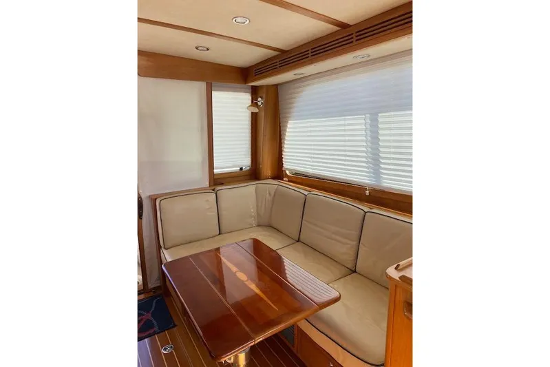  Yacht Photos Pics 2010 Sabre 40 Sedan interior with beige seating and wooden table.