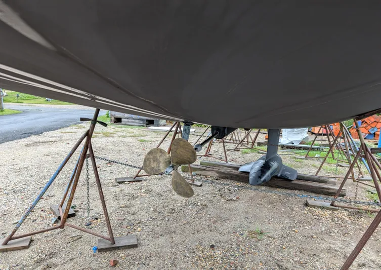  Yacht Photos Pics 2021 Jeanneau Sun Odyssey 349 sailboat on stands, showing propeller and keel.