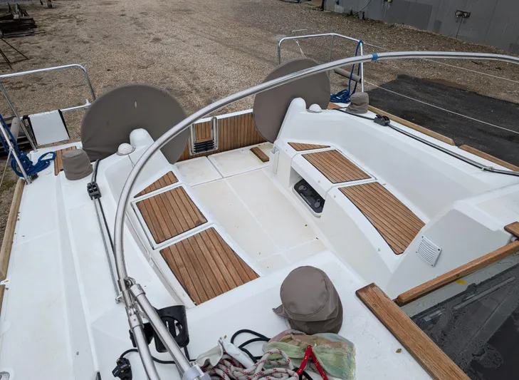  Yacht Photos Pics 2021 Jeanneau Sun Odyssey 349 sailboat cockpit with wooden seating and steering wheels.