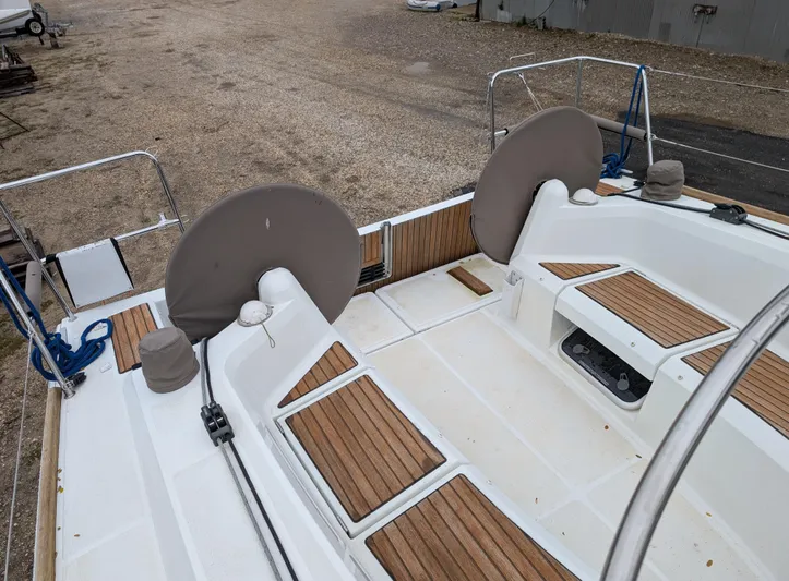  Yacht Photos Pics Jeanneau Sun Odyssey 349 sailboat deck, 2021 model, featuring dual steering wheels and teak accents.