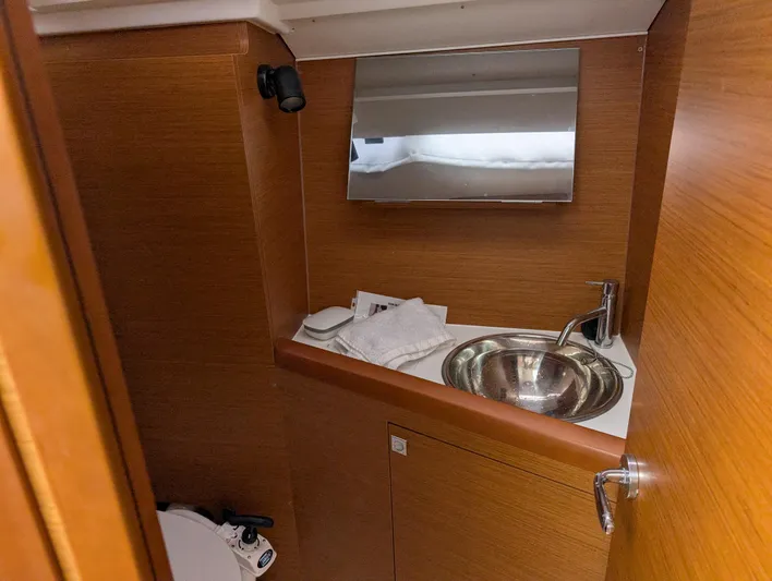  Yacht Photos Pics Interior of 2021 Jeanneau Sun Odyssey 349 yacht bathroom with sink and mirror.