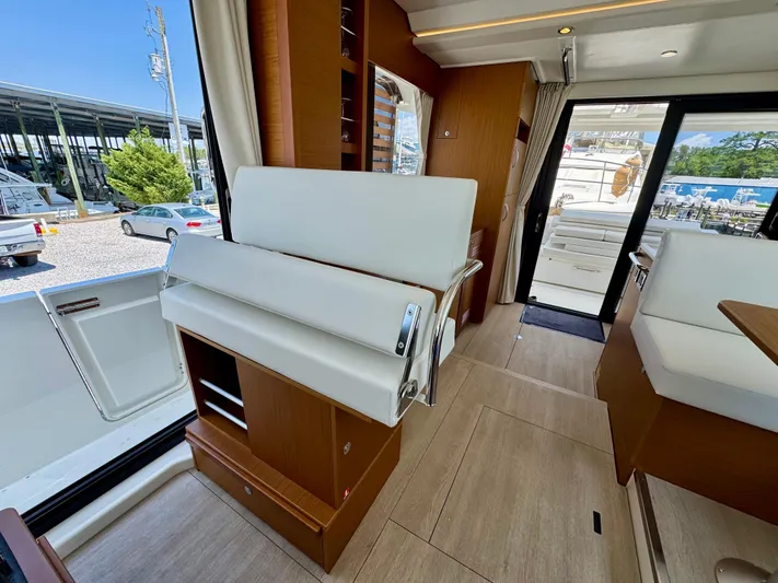  Yacht Photos Pics Interior of 2025 Beneteau Swift Trawler 41 Fly, featuring modern seating and wood finishes.