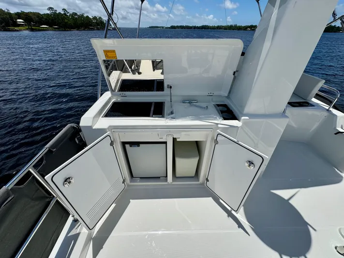  Yacht Photos Pics 2025 Beneteau Swift Trawler 41 Fly deck with open storage compartments and water view.