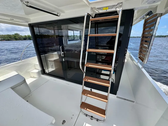  Yacht Photos Pics 2025 Beneteau Swift Trawler 41 Fly, featuring sleek deck and modern staircase design.