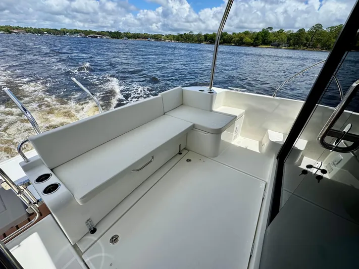  Yacht Photos Pics 2025 Beneteau Swift Trawler 41 Fly, spacious deck with seating, cruising on open water.