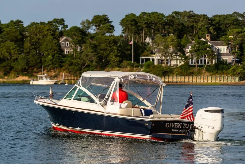 Given To Fly Yacht Photos Pics 2021 Hunt Yachts Harrier 26 cruising on a scenic waterway with American flag.