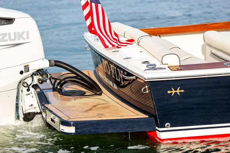 Given To Fly Yacht Photos Pics 2021 Hunt Yachts Harrier 26 with Suzuki engine, American flag, and teak swim platform.