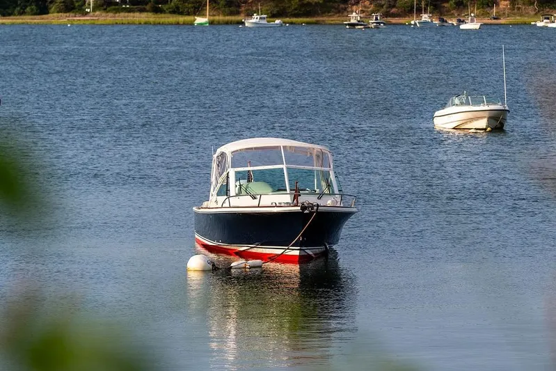 Given To Fly Yacht Photos Pics 2021 Hunt Yachts Harrier 26 boat anchored on calm water.