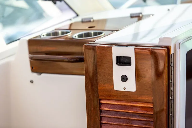 Given To Fly Yacht Photos Pics 2021 Hunt Yachts Harrier 26 interior with elegant wood finish and cup holders.
