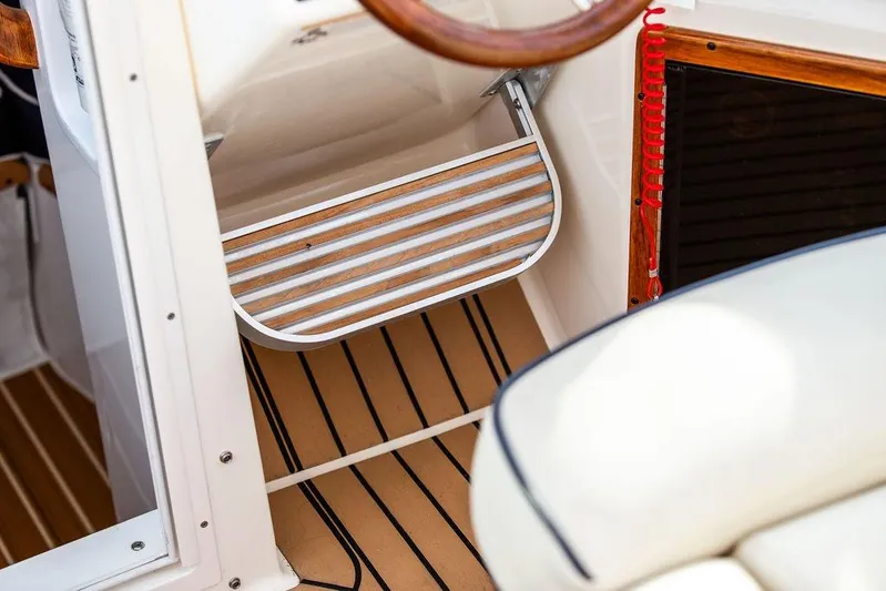 Given To Fly Yacht Photos Pics 2021 Hunt Yachts Harrier 26 interior with wooden step and nautical design elements.