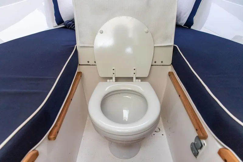 Given To Fly Yacht Photos Pics 2021 Hunt Yachts Harrier 26 interior with marine toilet and cushioned seating.