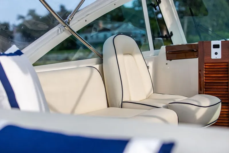 Given To Fly Yacht Photos Pics 2021 Hunt Yachts Harrier 26 interior with elegant white seating and wooden accents.