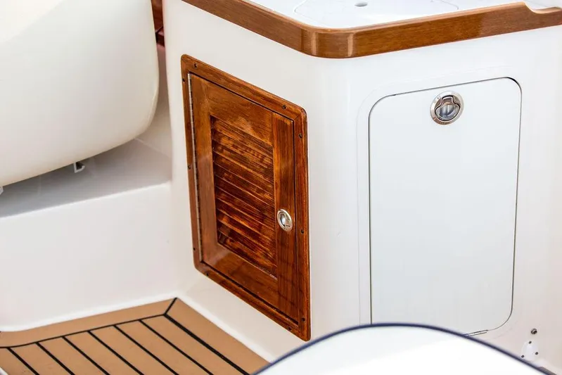 Given To Fly Yacht Photos Pics 2021 Hunt Yachts Harrier 26 interior with wooden cabinet and sleek design details.
