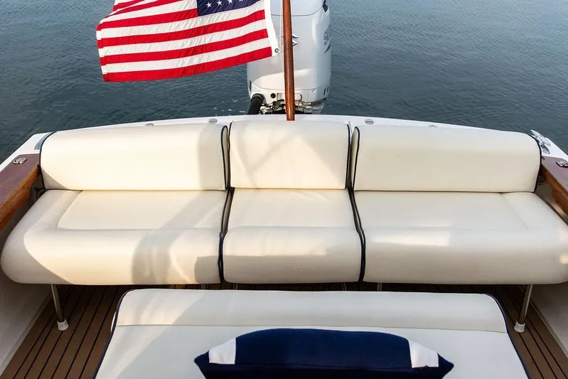 Given To Fly Yacht Photos Pics 2021 Hunt Yachts Harrier 26 with American flag, elegant seating, and outboard motor.