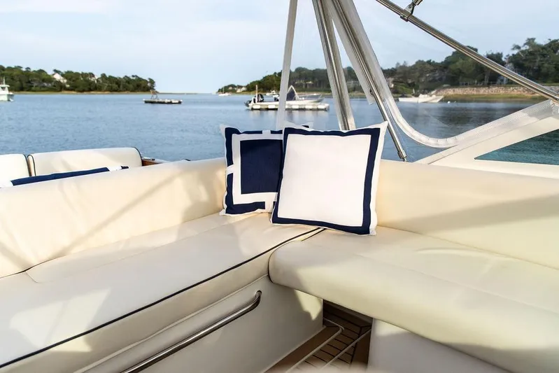 Given To Fly Yacht Photos Pics Luxurious seating on 2021 Hunt Yachts Harrier 26, featuring elegant cushions and scenic water view.