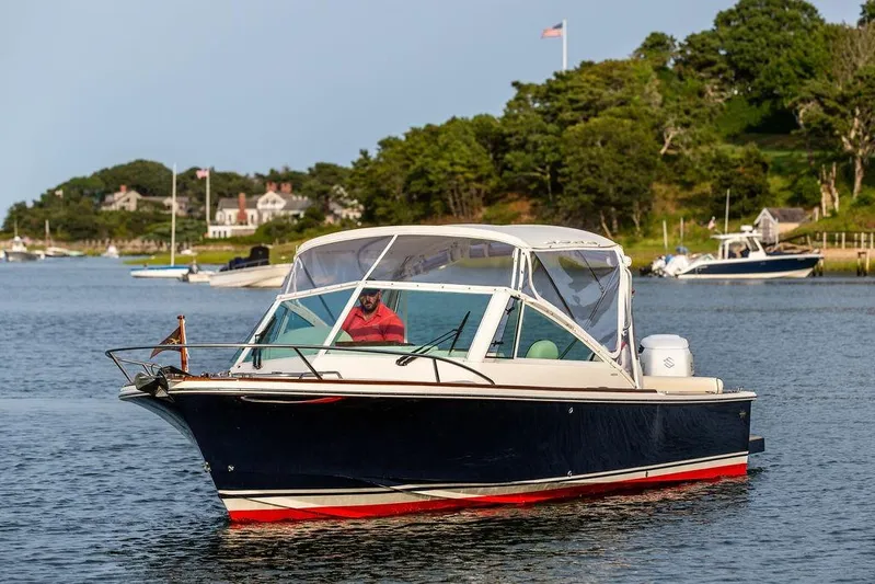 Given To Fly Yacht Photos Pics 2021 Hunt Yachts Harrier 26 cruising on a scenic waterway with lush greenery.