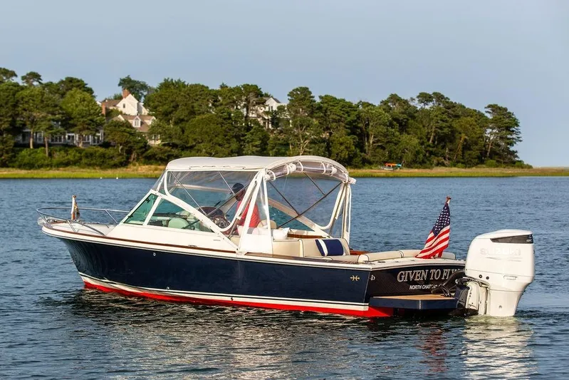 Given To Fly Yacht Photos Pics 2021 Hunt Yachts Harrier 26 on water, American flag, scenic background.