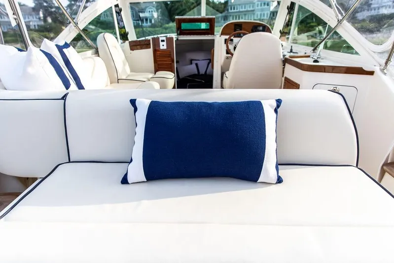 Given To Fly Yacht Photos Pics Luxurious interior of 2021 Hunt Yachts Harrier 26 with elegant seating and nautical decor.