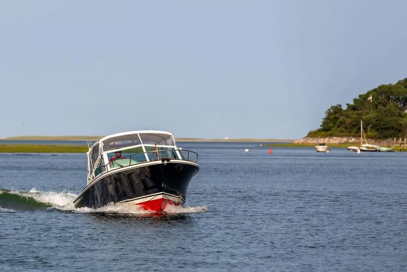 Given To Fly Yacht Photos Pics 2021 Hunt Yachts Harrier 26 cruising on a serene coastal waterway.