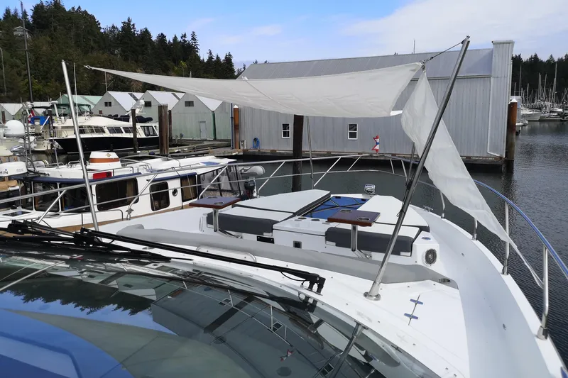 Yacht Photos Pics 2021 Cruisers Yachts 60 Cantius docked, featuring a sunshade and marina backdrop.
