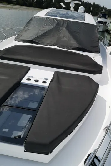  Yacht Photos Pics 2021 Cruisers Yachts 60 Cantius with sleek design and sunbathing area on deck.
