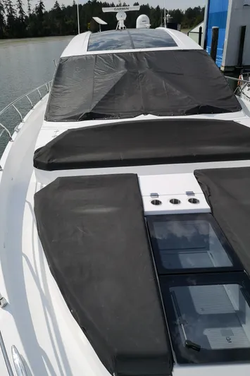  Yacht Photos Pics 2021 Cruisers Yachts 60 Cantius, sleek design, docked on calm water.