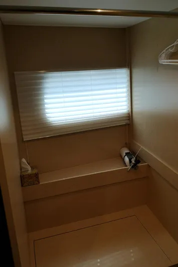  Yacht Photos Pics 2021 Cruisers Yachts 60 Cantius interior with window, shelf, and hanger.