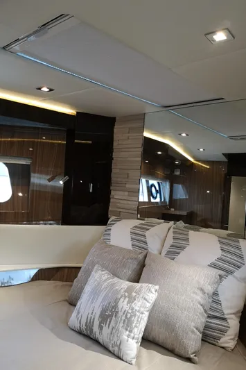  Yacht Photos Pics Luxurious interior of 2021 Cruisers Yachts 60 Cantius with modern design and plush bedding.