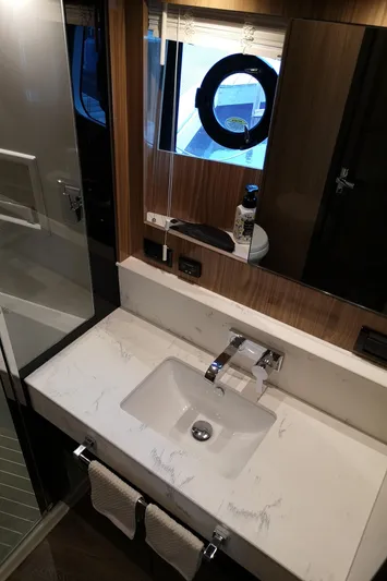  Yacht Photos Pics Luxurious bathroom in 2021 Cruisers Yachts 60 Cantius with modern sink and porthole window.