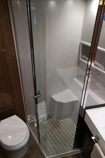  Yacht Photos Pics Luxurious bathroom in 2021 Cruisers Yachts 60 Cantius with glass shower and modern fixtures.