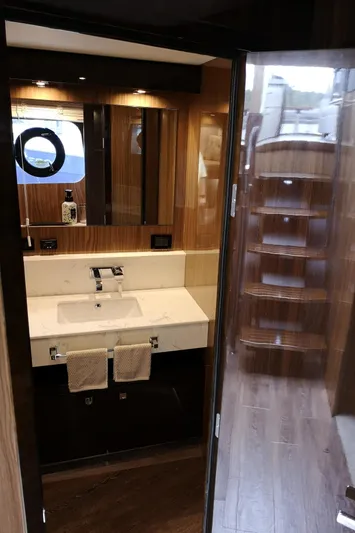  Yacht Photos Pics Luxurious bathroom interior of 2021 Cruisers Yachts 60 Cantius with modern fixtures and wood accents.