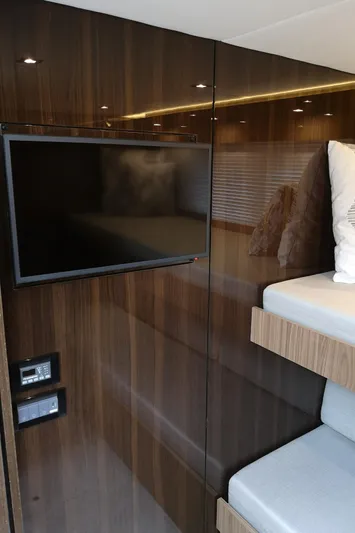  Yacht Photos Pics Interior of 2021 Cruisers Yachts 60 Cantius with TV and modern wood paneling.