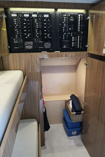  Yacht Photos Pics 2021 Cruisers Yachts 60 Cantius electrical panel and storage area with modern wood finish.