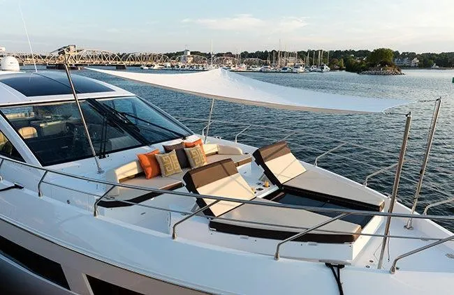  Yacht Photos Pics 2021 Cruisers Yachts 60 Cantius on water, featuring luxurious deck seating and sunshade.